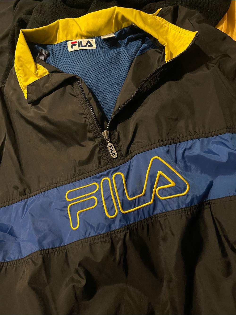 FILA Black Windbreaker with Blue Chest Stripe and Yellow Accents